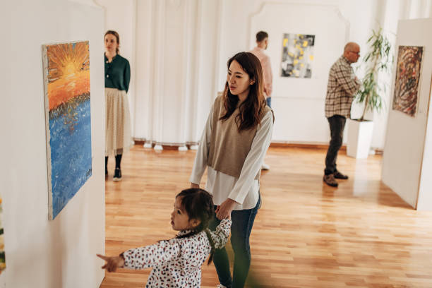 Mother and daughter in art gallery