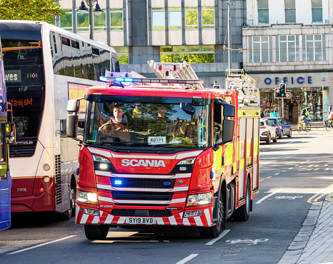Edinburgh, Scotland - A firefighter driving a fire engine in Edinburgh's city centre in response to an emergency call out.