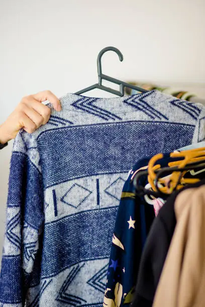 choosing blue wool warm clothes in the wardrobe
