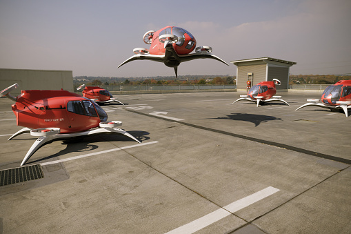 Firefighter eVTOL-Electric Vertical Take Off landing on rooftop landing pad between the buildings. (3d render)