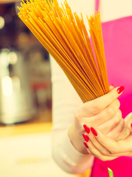 istock Woman holding long pasta 1398340500
