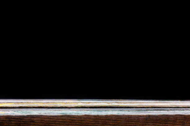 istock Empty wooden table top on a black background. Mock up for display product. 1398341484