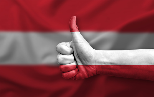 Hand making thumb up painted with flag of austria