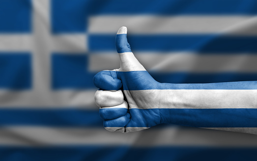 Hand making thumb up painted with flag of greece