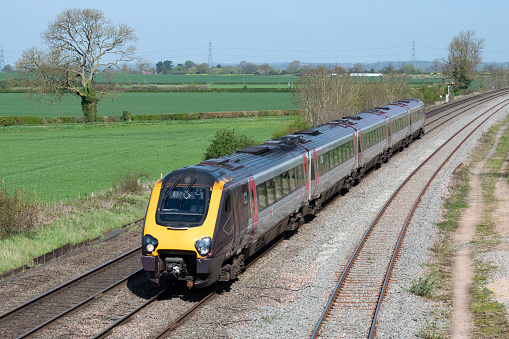 A Class 220 Voyager Cross Country Trains passenger train moving at speed on the line between Burton Upon Trent and Tamworth in the Midlands, England, UK