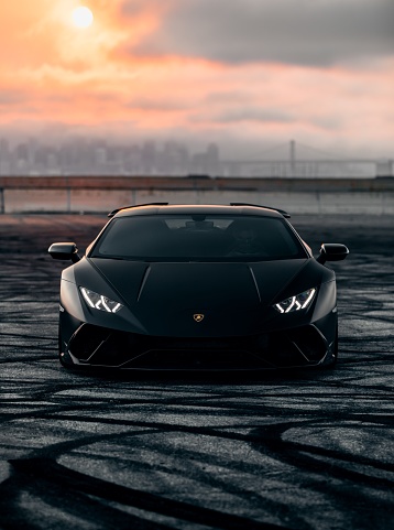 San Fran, CA, USA\nNovember 10, 2021\nBlack Lamborghini Huracan Performante with carbon accents parked with a city in the distance