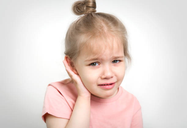 child with earache, toddler girl portrait ear pain concept. - young ears imagens e fotografias de stock