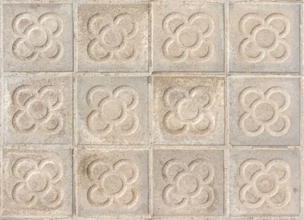 Photo of Barcelona pavement tiles with a flower, panot slabs with symbol texture top view