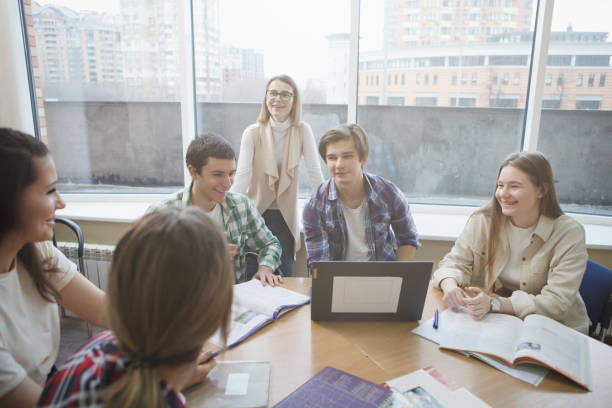 istock Teacher with college students in class 1398354140