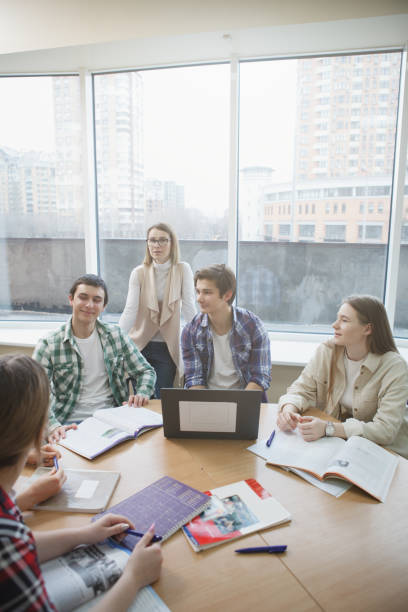 istock Teacher with college students in class 1398354171
