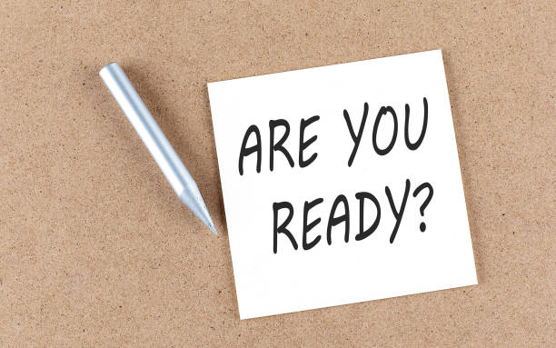 istock ARE YOU READY text on sticky note on a cork board with pencil , 1398354310