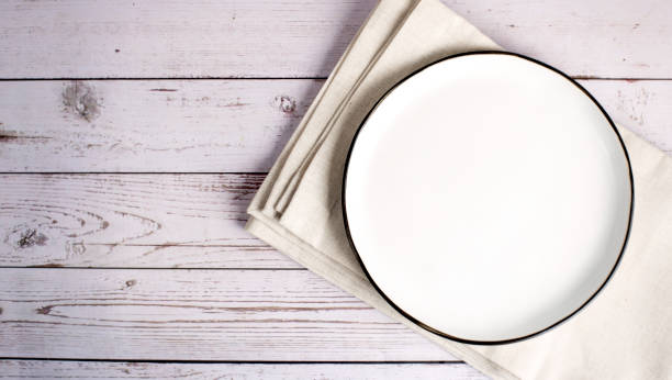 istock ceramic plate on napkin on white wooden table.Flat lay 1398354341
