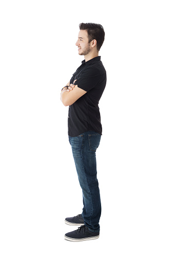 Side view posing of smiling guy, standing with his arms crossed.
