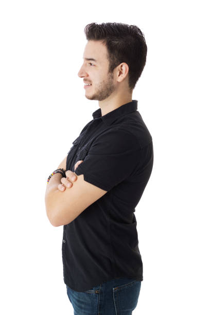 istock Side view posing of smiling guy, standing with his arms crossed 1398355805
