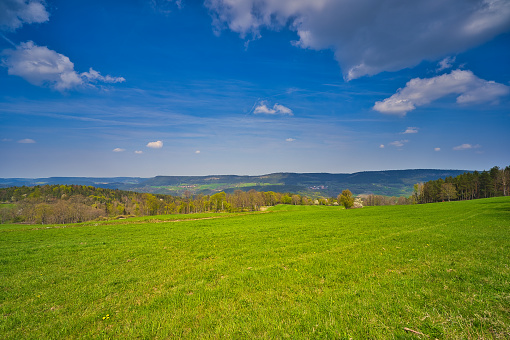 Panoramic view of summer landscape with green meadows, forests, village and blue sky with white clouds - Czech Republic, Europe