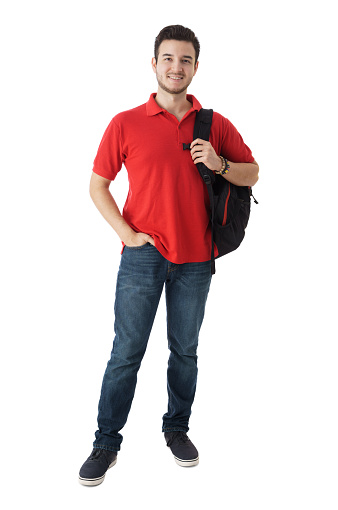 Full shot of university student , holding backpack and looking at camera over white background.