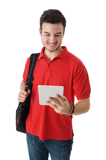 A latin male student  holding and looking at a digital tablet.