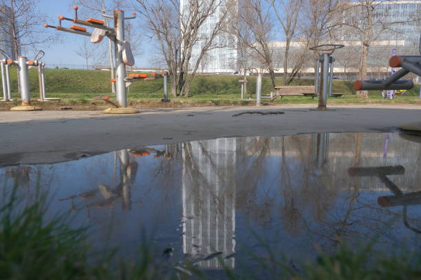 istock Reflection of building on small puddle and water. 1398359112