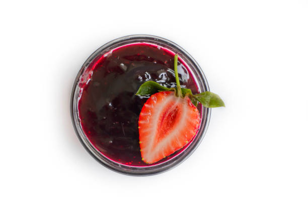 istock Strawberry jam in glass isolated on white background 1398362901
