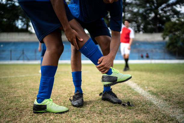 istock Athlete supporting injured player on soccer field 1398367083
