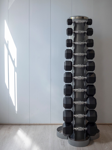 Weights arranged in a gymnasium. Material to exercise the muscles. Gym, healthy living, self-improvement.