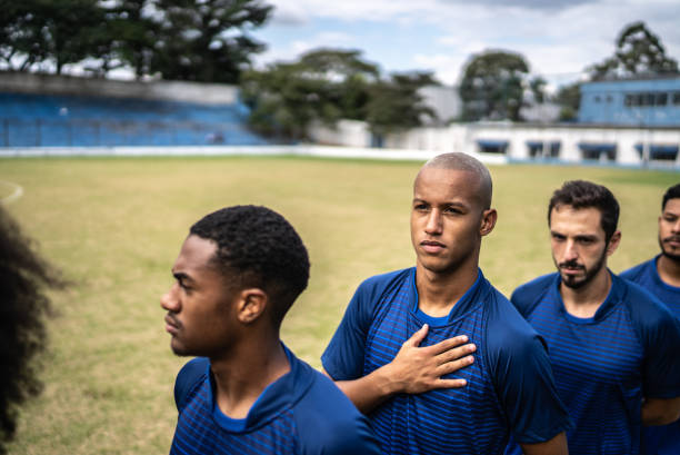 istock Soccer players during anthem playing before a match 1398367917