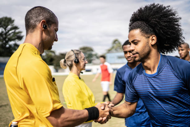 istock Soccer players greeting referees before a match 1398368015