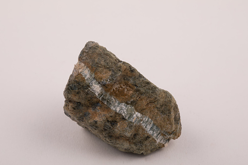 Asbestos family mineral band in geological rock sample