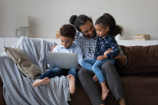 istock Happy African American family using computer at home. 1398368996