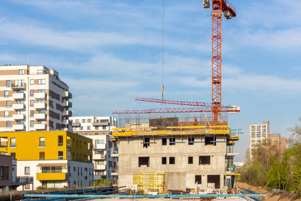 istock Crains on construction site of building. Construction background copy space 1398374923