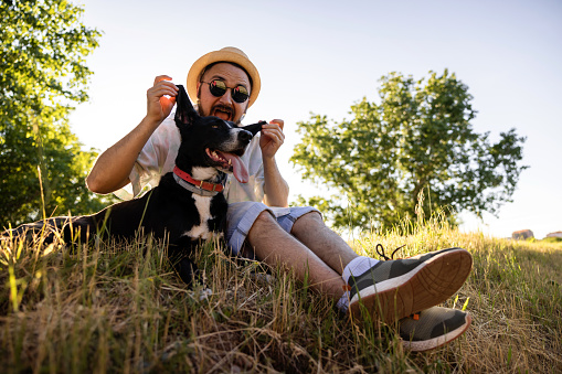 Portrait of Caucasian ethnicity young adult man and his dog