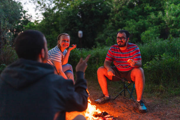istock Three young friends sitting around a campfire roasting marshmallows at dusk 1398377407