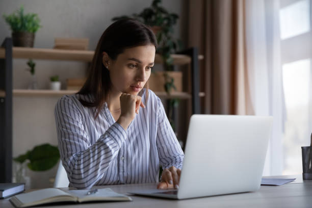 istock Thoughtful focused student girl working at laptop from home 1398377560