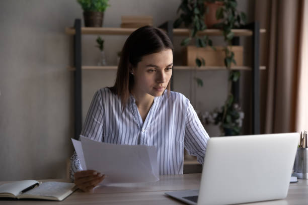istock Focused busy young office employee working at laptop 1398377567