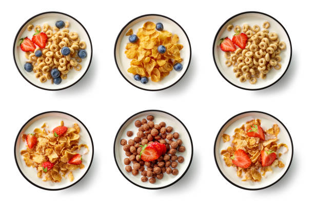 breakfast cereal with milk and berries bowls of breakfast cereal with milk and berries isolated on white background, top view cereal plant stock pictures, royalty-free photos & images