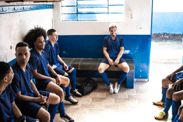 istock Soccer players sitting in locker room 1398379406