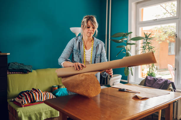 istock Woman tailor working from home and tailoring beautiful clothes 1398379432