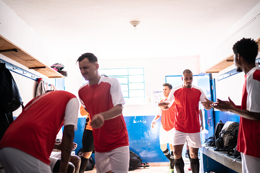 Soccer players preparing for a match in the locker room