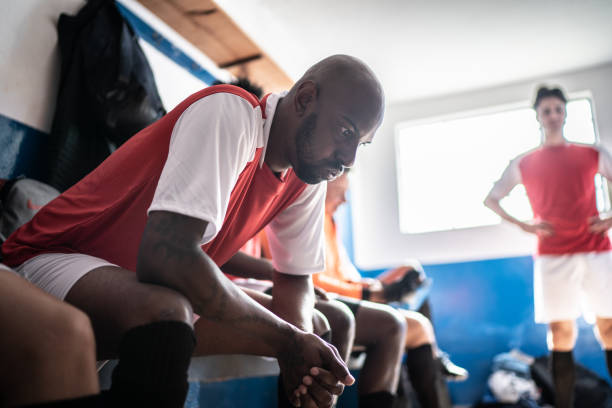 istock Anxious soccer player before a match in the locker room 1398379602