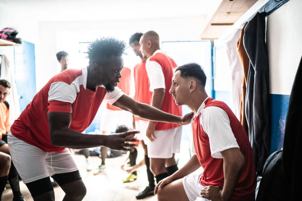 istock Team captain talking to a player before a match in the locker room 1398379639