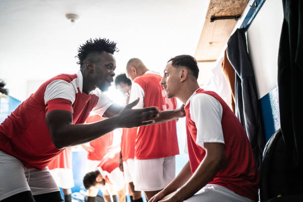 istock Team captain talking to a player before a match in the locker room 1398379652