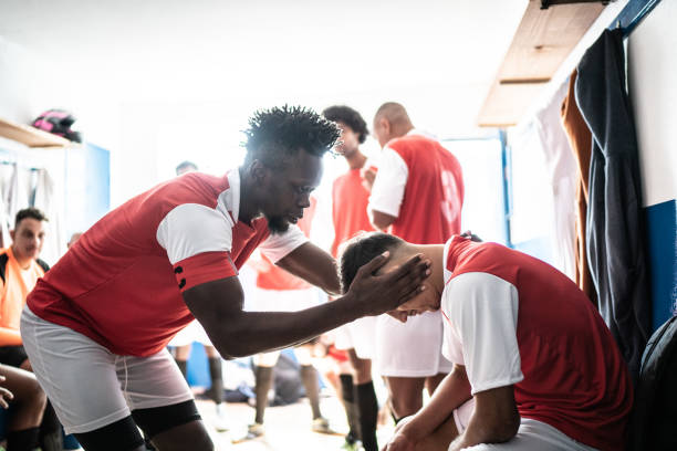 istock Team captain talking to a player before a match in the locker room 1398379667