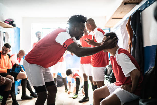 istock Team captain talking to a player before a match in the locker room 1398379669
