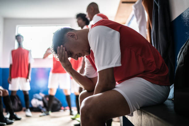 istock Worried soccer player in the locker room 1398379724