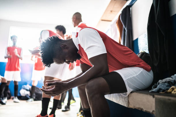 istock Soccer player praying before a match in the locker room 1398379725