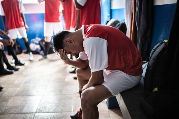 Soccer player worried in the locker room