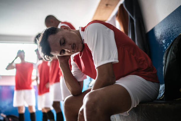 istock Worried soccer player in the locker room 1398380231