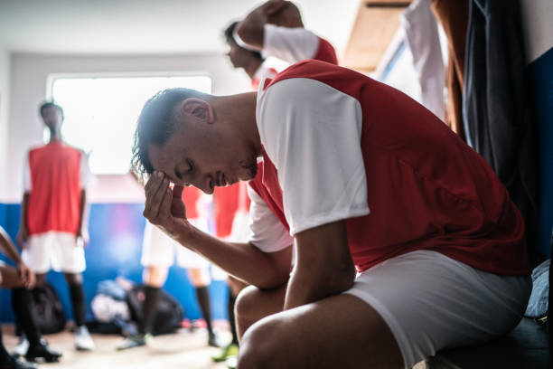 istock Worried soccer player in the locker room 1398380232