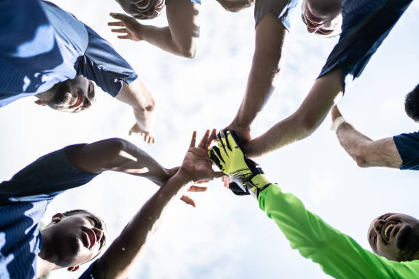istock Stack of hands showing unity of soccer players 1398380339