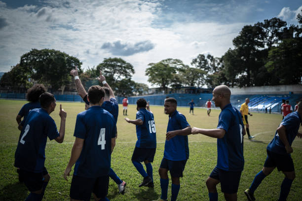 istock Soccer players celebrating a goal 1398380344